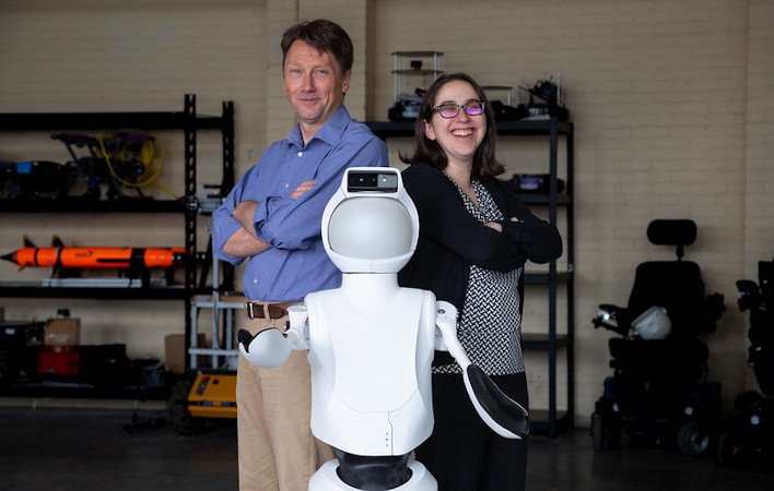 OSU robotics researchers Bill Smart and Naomi Fitter with a Quori robot