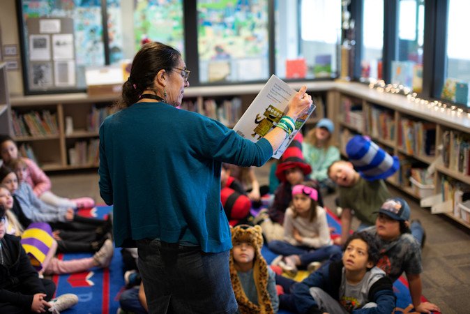  Redmond School District Librarian Pia Alliende reads to students at Vern Patrick Elementary School during a Read Across America event this year