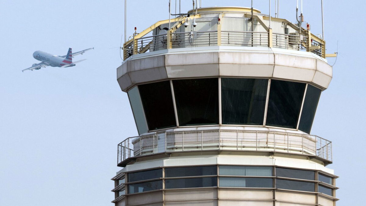 <i>Saul Loeb/AFP/Getty Images</i><br/>An American Airlines Airbus A319 airplane takes off past the air traffic control tower at Ronald Reagan Washington National Airport in Arlington