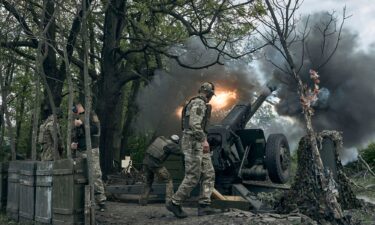 Ukrainian soldiers fire a cannon near Bakhmut