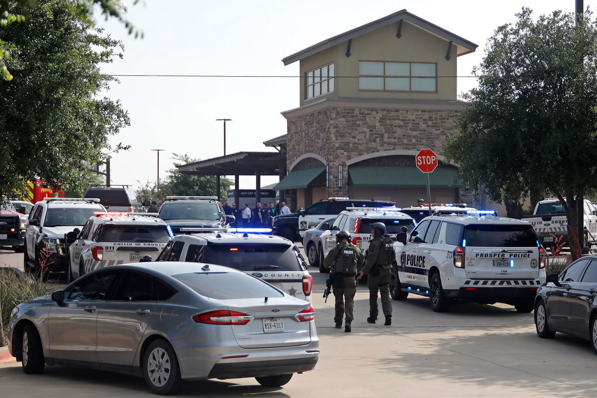 <i>Stewart  F. House/Getty Images</i><br/>Emergency personnel work the scene of a shooting at Allen Premium Outlets on May 6