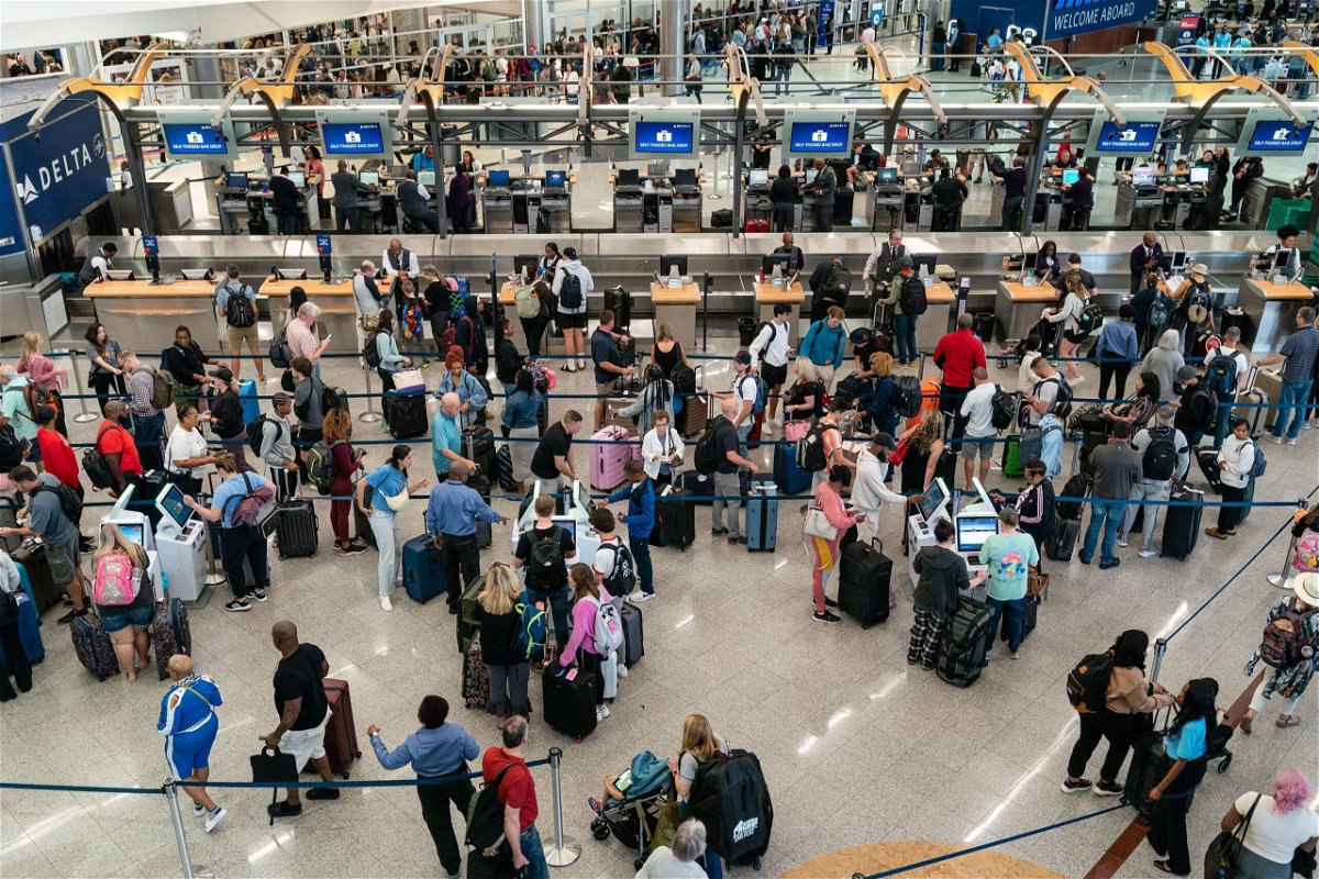 <i>Elijah Nouvelage/Bloomberg/Getty Images</i><br/>Travelers make their way through Hartsfield-Jackson Atlanta International Airport on Thursday