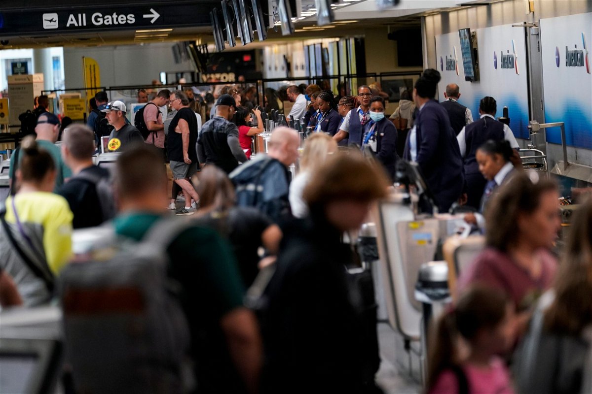 <i>Erik Verduzco/AP</i><br/>People check in at the American Airlines ticket counter at Charlotte Douglas International Airport on Thursday