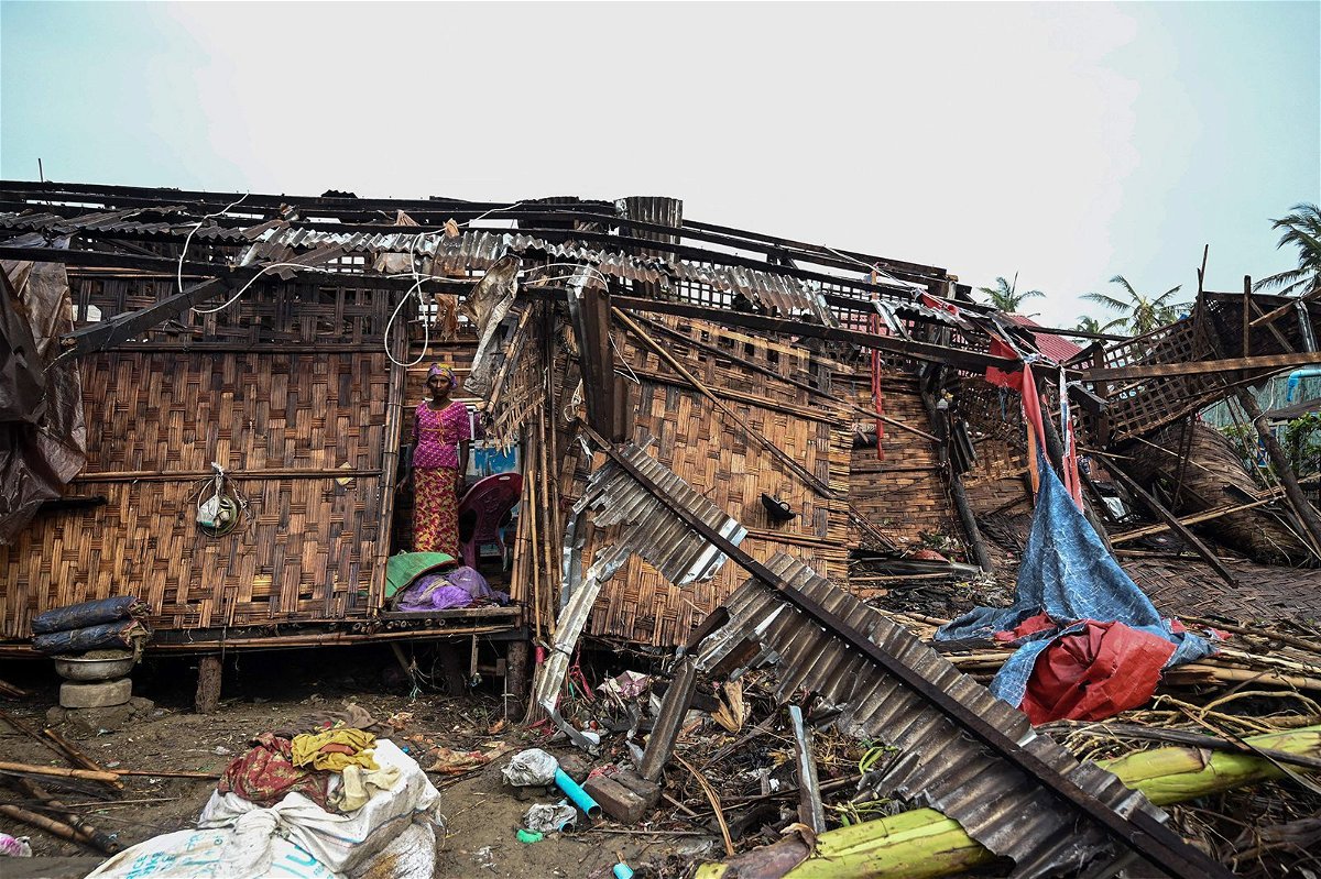 <i>Sai Aung Main/AFP/Getty Images</i><br/>A Rohingya woman stands in her damaged house at Basara refugee camp in Sittwe on May 16 following Cyclone Mocha.