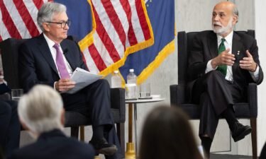 Federal Reserve Board Chair Jerome Powell and former Federal Reserve Board Chair Ben Bernanke (R) participate in a discussion at the Federal Reserve Board building in Washington
