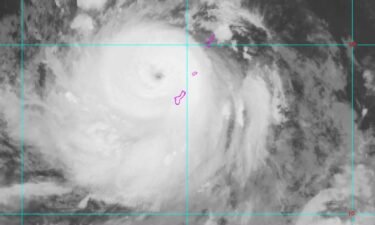An NOAA satellite image shows Typhoon Mawar passing over Guam on May 24