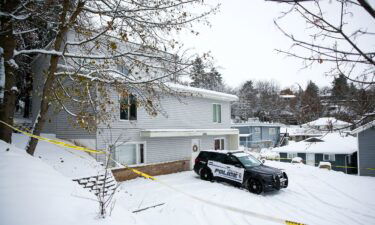 Police tape surrounds the residence where four University of Idaho students were killed as police monitor the scene November 30 in Moscow