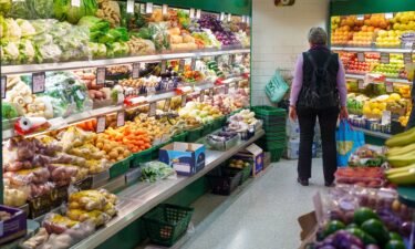 A shopper browses fruit and vegetables at an indoor market in Sheffield