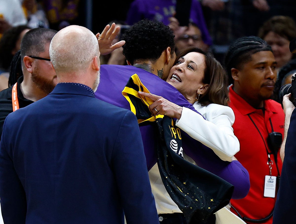 <i>Ronald Martinez/Getty Images</i><br/>Vice President Kamala Harris hugs Brittney Griner before the game.