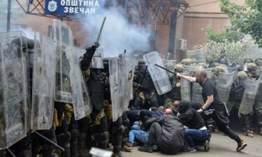 NATO's peacekeeping Kosovo Force (KFOR) clash with local protesters at the entrance of the municipality office