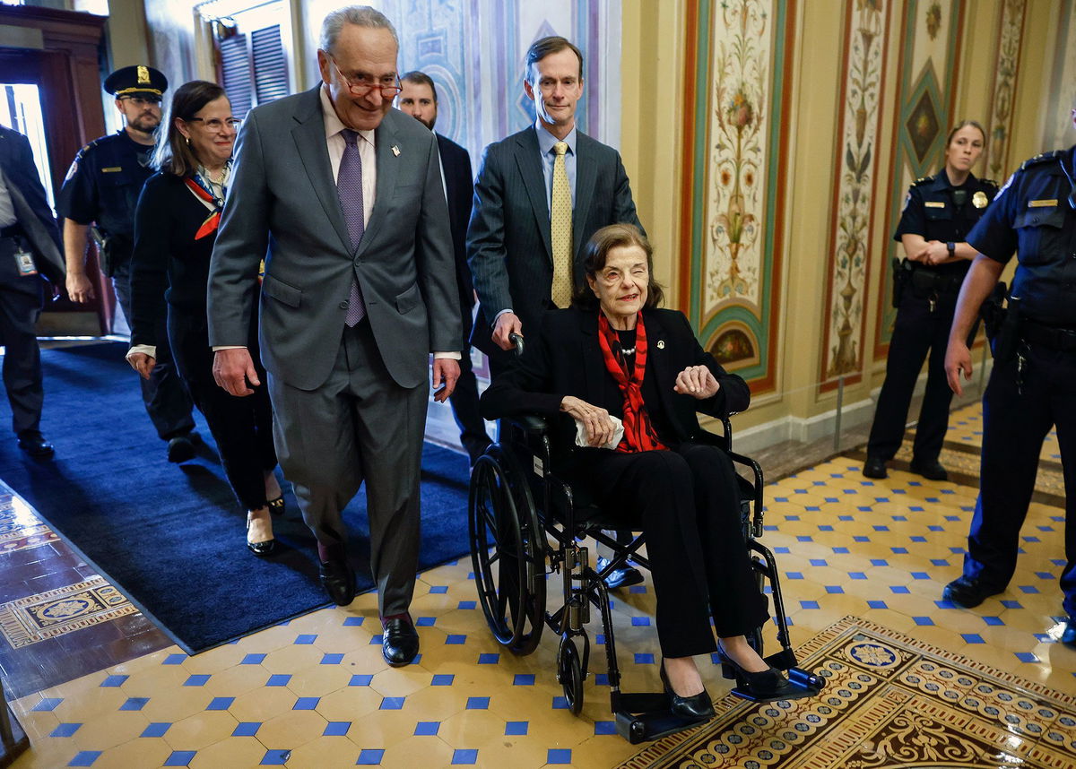 <i>Kevin Dietsch/Getty Images</i><br/>Senate Majority Leader Charles Schumer escorts Sen. Dianne Feinstein as she arrives at the Capitol following a long absence due to health issues on May 10 in Washington