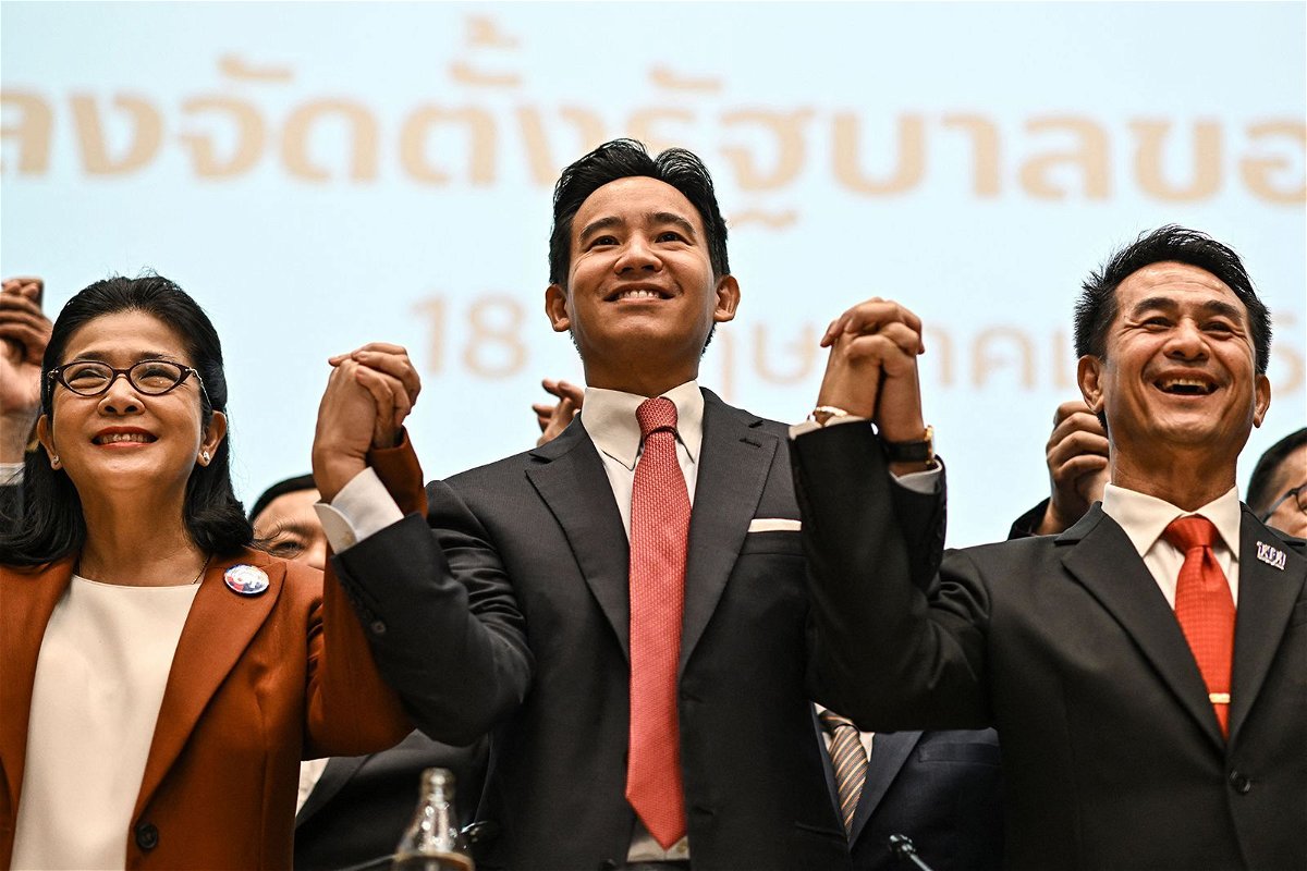 <i>Manan Vatsyayana/AFP/Getty Images</i><br/>Move Forward Party leader and prime ministerial candidate Pita Limjaroenrat (C) poses with potential coalition partners including Pheu Thai Party leader Chonlanan Srikaew (R) in Bangkok on May 18.