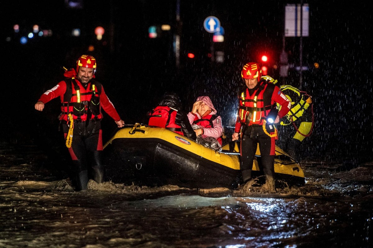 <i>AFP/Getty Images</i><br/>Firemen and civil protection rescuers evacuate a woman with an inflatable boat in the city of Forli in Italy's northern Emilia-Romagna region on Wednesday following severe flooding.