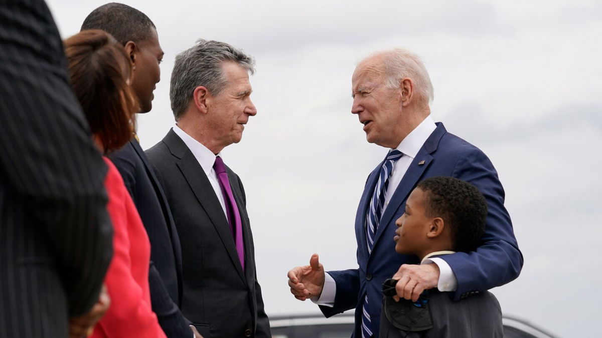 <i>Carolyn Kaster/AP</i><br/>President Joe Biden talks with North Carolina Gov. Roy Cooper as he arrives at Piedmont Triad International Airport in Greensboro in April 2022.