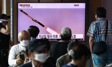 People watch a television screen showing a file image of a North Korean missile launch at the Seoul Railway Station on August 17