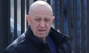The founder of the Wagner private mercenary group Yevgeny Prigozhin leaves a cemetery before the funeral of a Russian military blogger who was killed in a bomb attack in a St Petersburg cafe