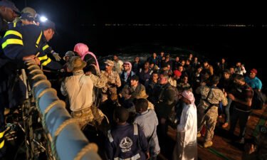 Saudi forces hoist evacuees aboard a vessel during a rescue operation from Port Sudan to Jeddah