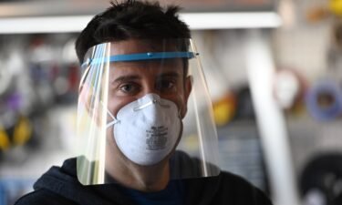 Jeremy Reitman poses wearing one of the medical quality personal protective equipment (PPE) face shields for doctors and nurses that he is making in his garage on 3D printers in Calabasas