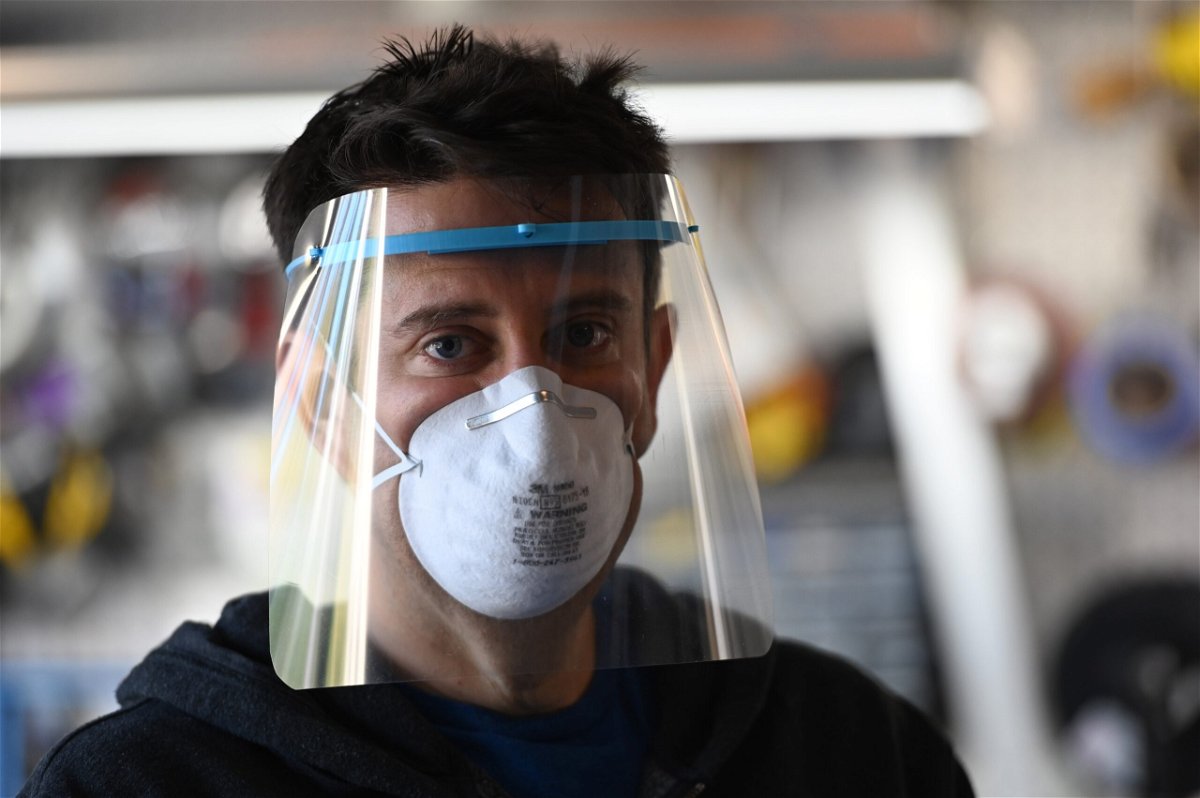 <i>ROBYN BECK/AFP/AFP via Getty Images</i><br/>Jeremy Reitman poses wearing one of the medical quality personal protective equipment (PPE) face shields for doctors and nurses that he is making in his garage on 3D printers in Calabasas