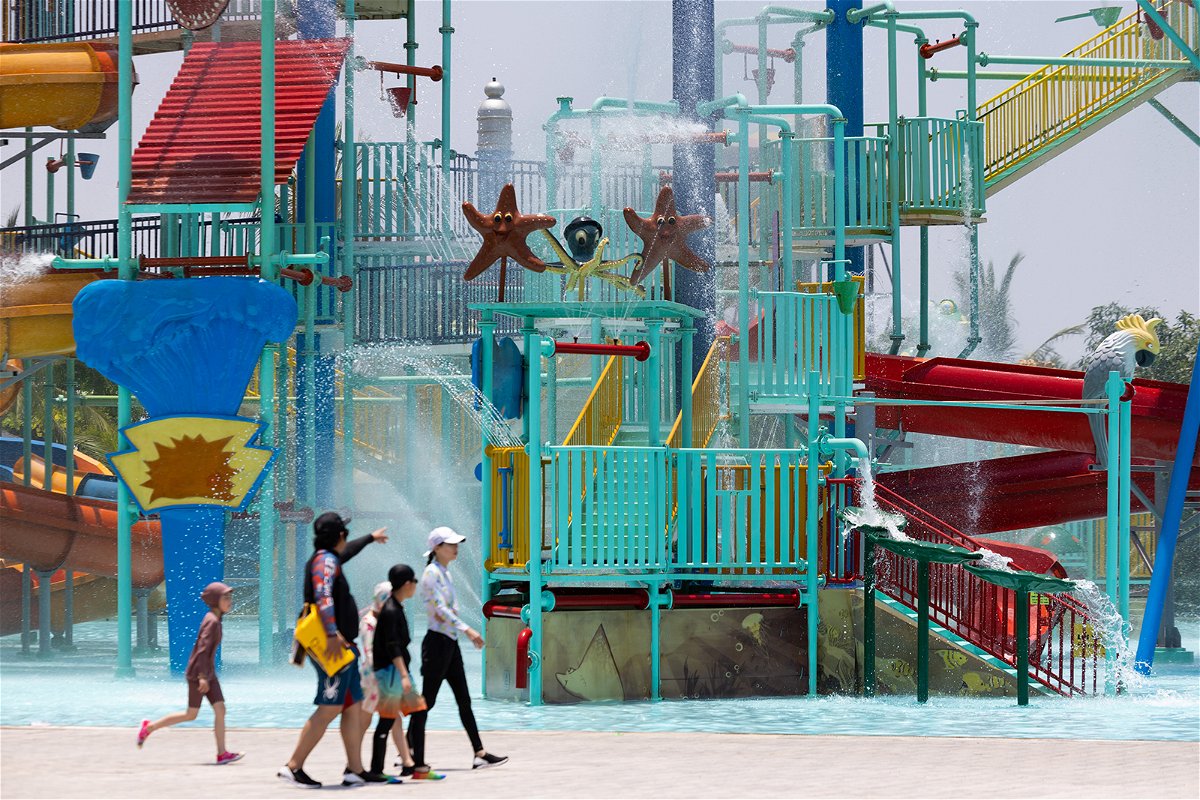 <i>SeongJoon Cho/Bloomberg/Getty Images</i><br/>Visitors cool off at an amusement park in Hoi An