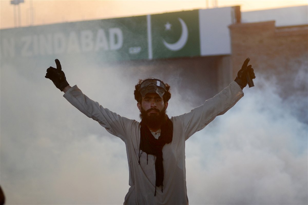 <i>Hussain Ali/Anadolu Agency/Getty Images</i><br/>A demonstrator is seen as Pakistani police use tear gas against supporters of former Prime Minister Imran Khan during a protest in Peshawar
