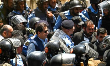Policemen escort Pakistan's former prime minister