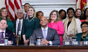 Maryland Gov. Wes Moore and state lawmakers pose for photos at a bill-signing ceremony on May 3 in Annapolis. Moore signed bills into law Wednesday that enshrine abortion rights and protect gender-affirming care.