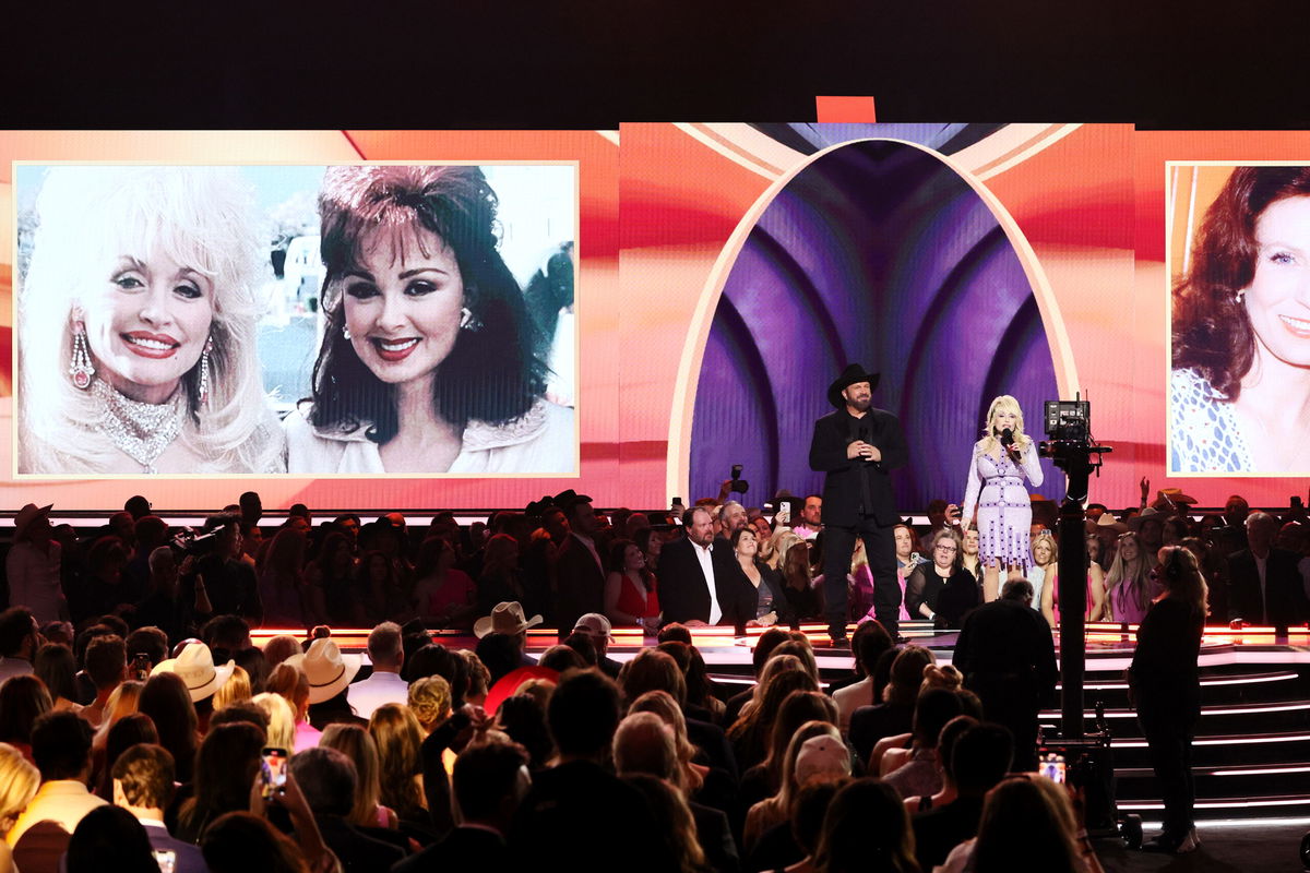 <i>Theo Wargo/Getty Images</i><br/>Co-hosts Garth Brooks and Dolly Parton speak onstage during the 58th Academy Of Country Music Awards.