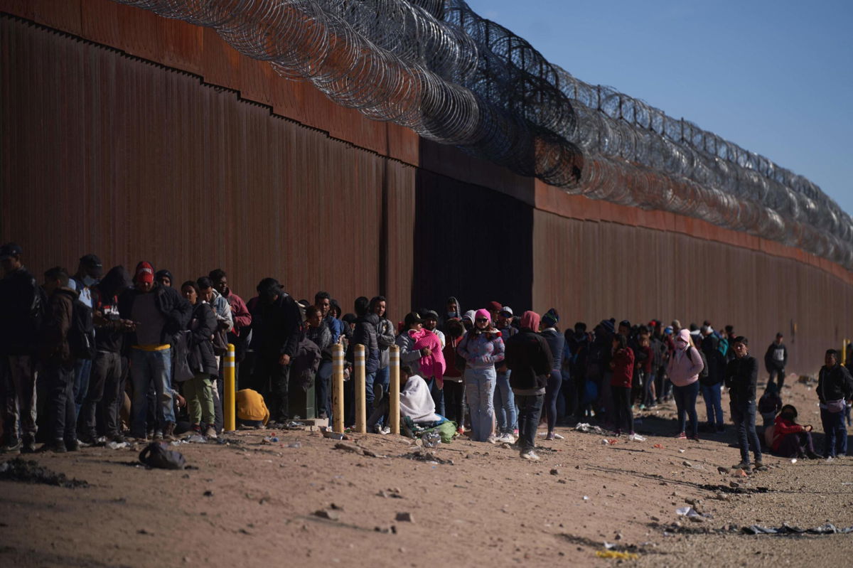 <i>Allison Dinner/AFP/Getty Images</i><br/>Hundreds of migrants line up to be processed by US Border Patrol under the Stanton Street Bridge after illegally entering the US