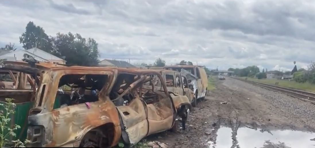 <i></i><br/>It looks like a cluttered junkyard filled with discarded vehicles