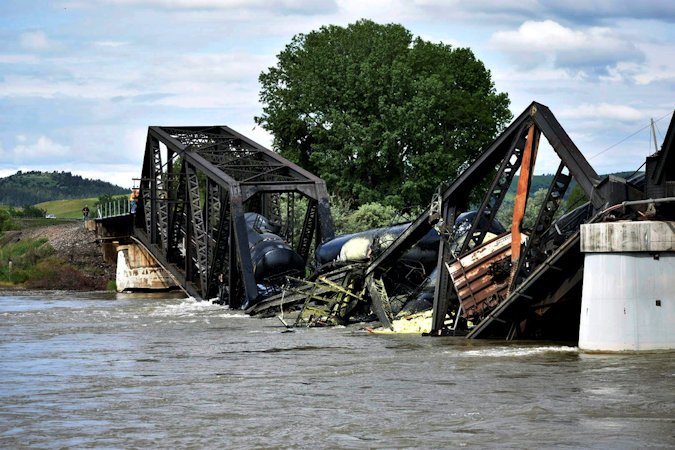 Several train cars are immersed in the Yellowstone River after a bridge collapse near Columbus, Mont., on Saturday