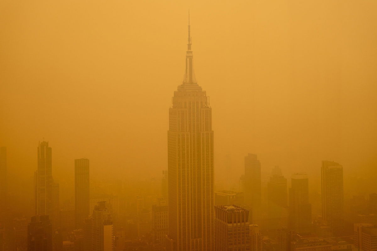 <i>David Dee Delgado/Getty Images</i><br/>Smoky haze from wildfires in Canada diminishes the visibility of the Empire State Building on June 7 in New York City.