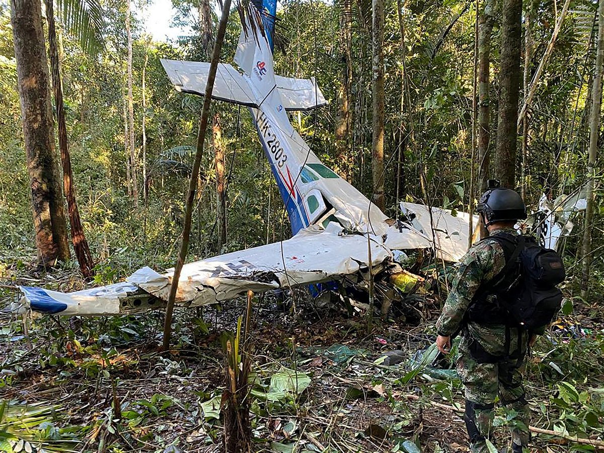 <i>Colombian Military Forces/Reuters</i><br/>A soldier stands next to the wreckage of a plane during the search for child survivors from a Cessna 206 plane that crashed in the jungle more than two weeks ago in the jungles of Caqueta