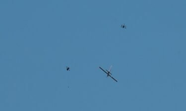 Drone manufactures practice attacking a fixed-wing aircraft during a drone competition organized by the Ukrainian government.