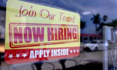 A 'Now Hiring' sign is seen here posted in the window of a restaurant looking to hire workers on May 5 in Miami