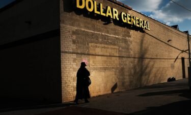 A woman walks by a Dollar General store on December 11