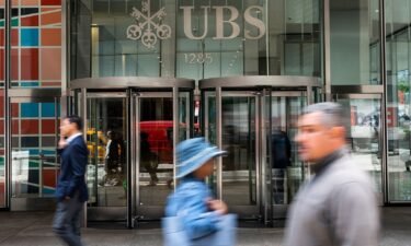 People walk in front of the UBS building in Manhattan