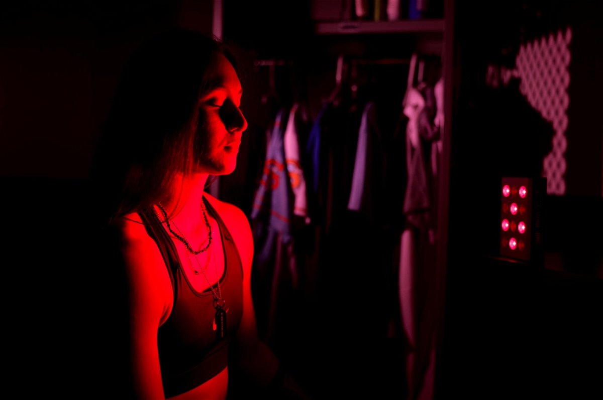 <i>Al Bello/Getty Images</i><br/>Kelsie Whitmore of the Staten Island FerryHawks baseball team uses red light therapy in her locker room on September 8