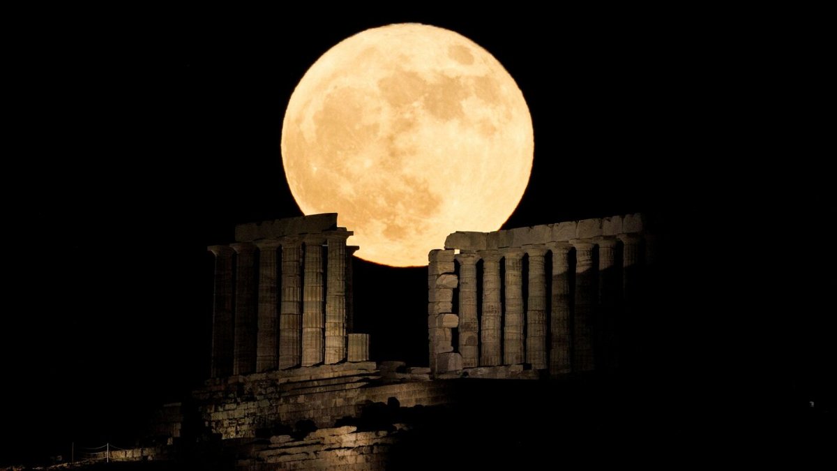 <i>Alkis Konstantinidis/Reuters</i><br/>The full strawberry moon rises behind the Temple of Poseidon at Cape Sounion near Athens