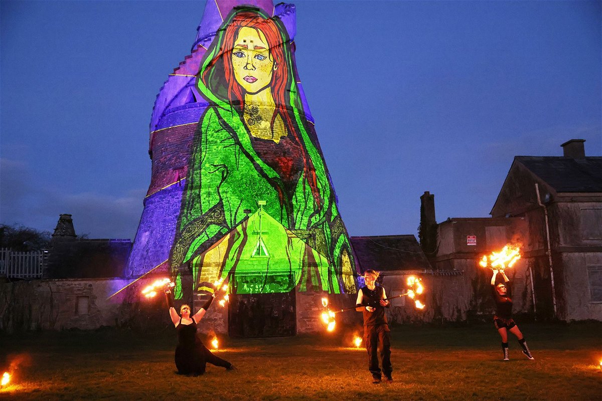 <i>Peter Morrison/AP</i><br/>Dancers perform in front of an image of St. Brigid projected onto The Wonderful Barn in Leixlip