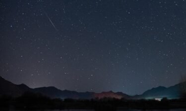 The Geminid meteor shower streaks across the night sky over the Lhasa River in Tibet on December 14