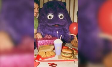 A photo from McDonald's Instagram ad campaign for "Grimace's birthday" styled to look like a retro photo shoot. Grimace was introduced at McDonald's in the 1970s.
