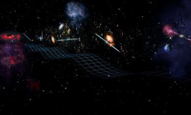 An artist's rendering of gravitational waves from a pair of close-orbiting black holes (visible on the left in the distance). The waves are passing by several pulsars and Earth (on the right).