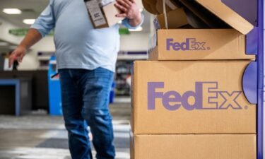 A customer walks into a FedEx store in December 2022 in Houston