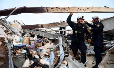 Search and rescue teams look for survivors in a former Dollar General after a tornado in Matador