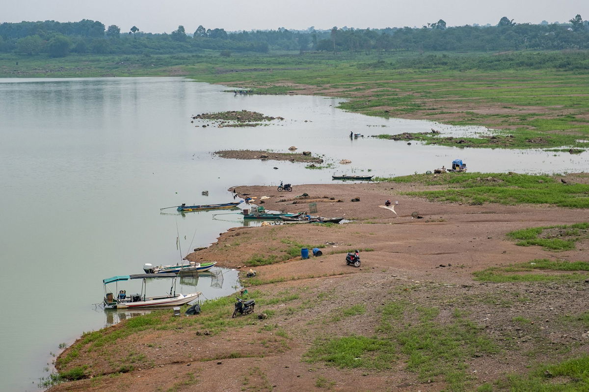 <i>Linh Pham/Bloomberg/Getty Images</i><br/>People fish along exposed banks