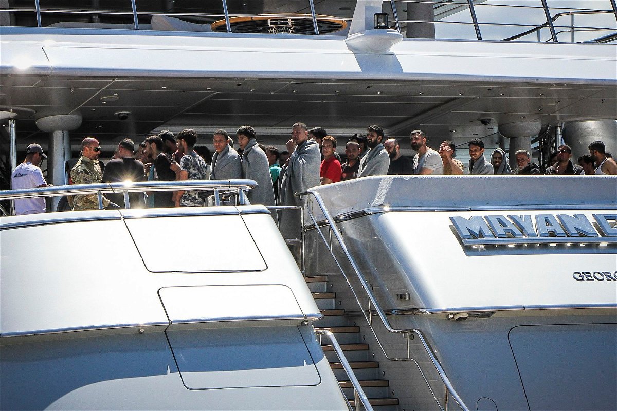 <i>Stringer/Eurokinissi/AFP/Getty Images</i><br/>Survivors arrive in Kalamata on board the Mayan Queen superyacht.