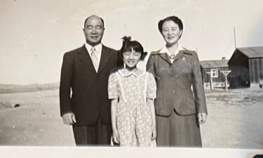 Amy Iwasaki Mass was a first grader when her family was forced to live in an internment camp in Wyoming. Here she poses with her parents while incarcerated.