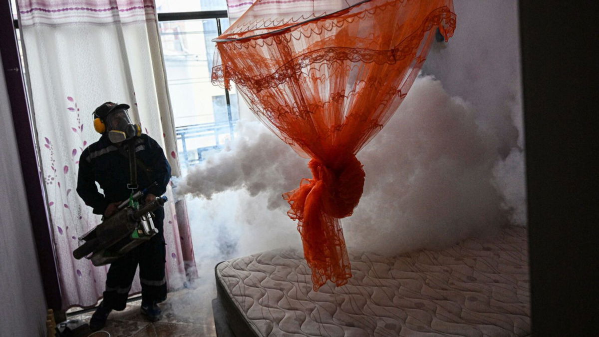 <i>Ernesto Benavides/AFP/Getty Images</i><br/>A worker fumigates a house against the Aedes aegypti mosquito to prevent the spread of dengue fever in a neighborhood in Piura