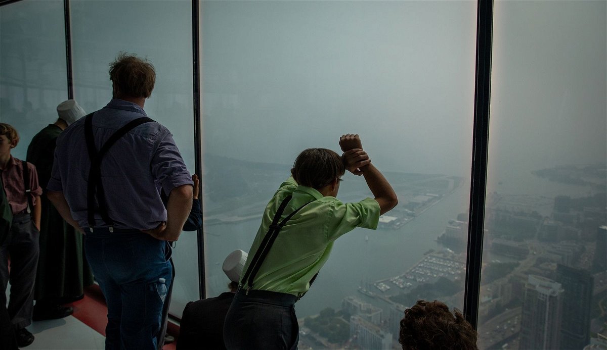 <i>Arif Balkan/NurPhoto/Getty Images</i><br/>The Toronto skyline is covered by smoke on June 28 at the CN Tower.